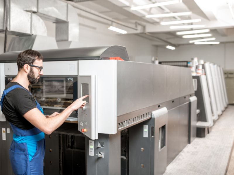 Technician operating advanced production machinery